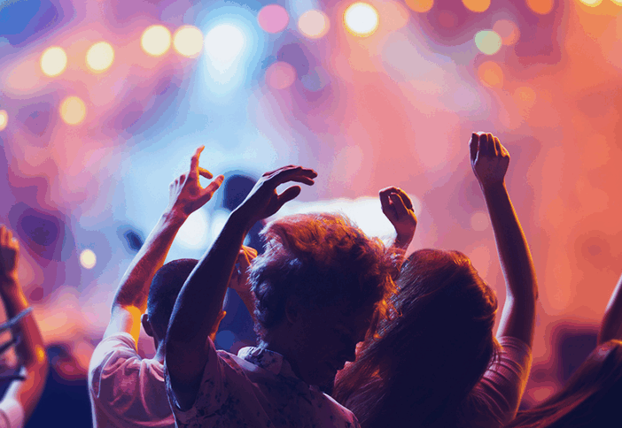 group of people dancing at a concert